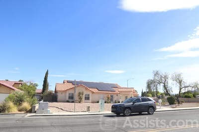 Exterior view of Palms Care Home facility with vehicle