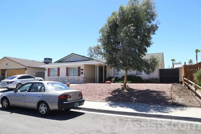 Exterior view of a care home with landscaped yard