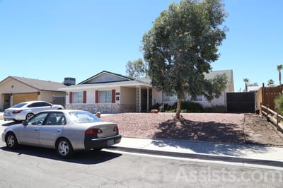 Exterior view of a care home with landscaped yard