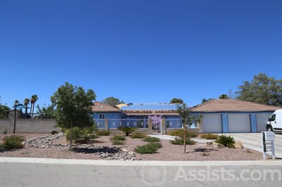 Exterior view of a senior living facility with landscaping