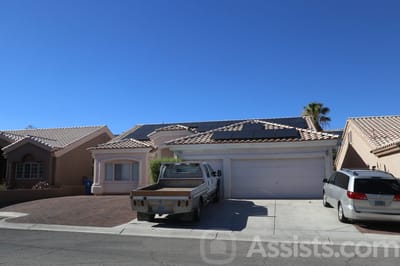 Exterior of a home with a van and pickup truck parked