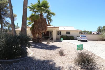 Exterior view of Dignified Care Manor with palm trees