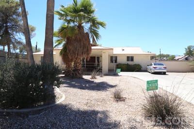 Exterior view of Dignified Care Manor with landscaping