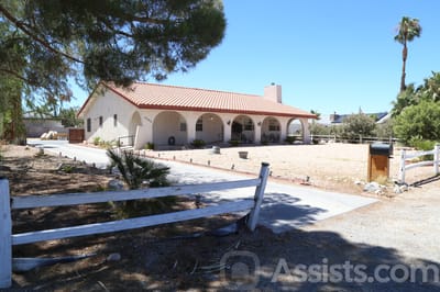 Exterior view of a senior care facility with a landscaped front area