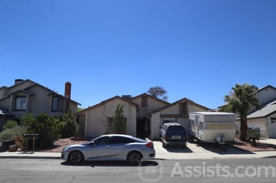 Exterior view of a residential building with parked cars