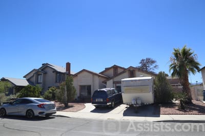 Exterior view of a residential building with vehicles