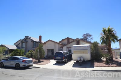 Exterior view of a residential building with vehicles