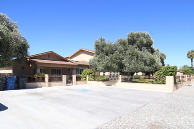 Exterior view of a senior living facility with trees