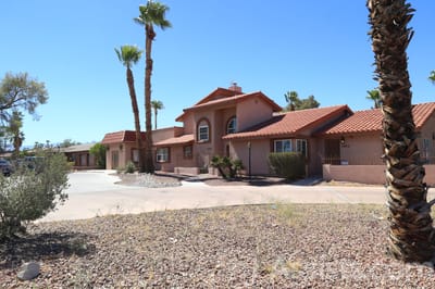 Exterior view of a nursing home facility with palm trees