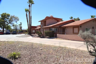 Exterior view of Livingston Home II facility with palm trees