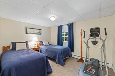 Cozy resident room with two beds and exercise equipment