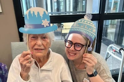 Resident and staff member enjoying a festive activity