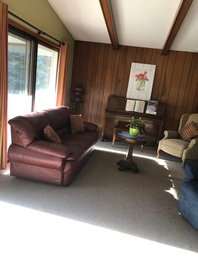 Cozy interior lounge with seating area and light streaming in