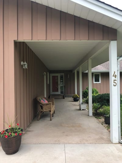 Front porch of the River of Life facility with flower pots