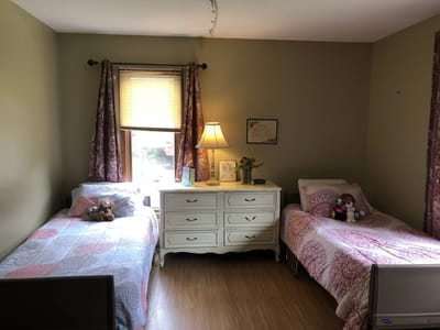 Cozy resident room with two beds and personal items