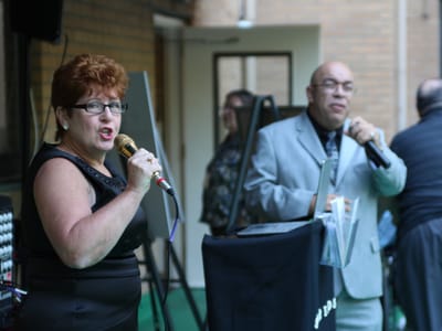 Residents singing karaoke during a community event