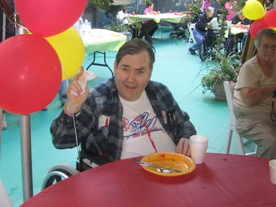 Resident enjoying a meal at an outdoor event