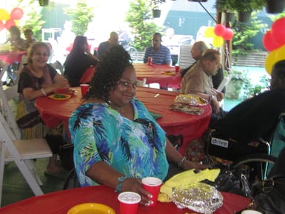 Residents enjoying an outdoor event with food and decorations