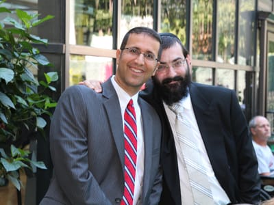 Two men smiling in a common area of the facility