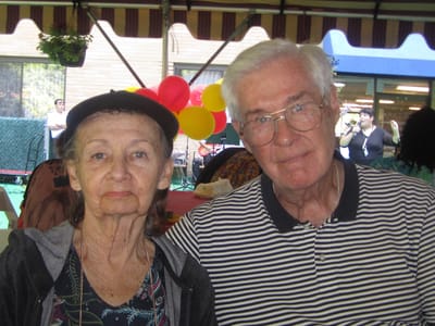 Two residents enjoying an event with balloons in the background