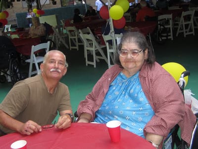 Residents enjoying a celebration outdoors with balloons