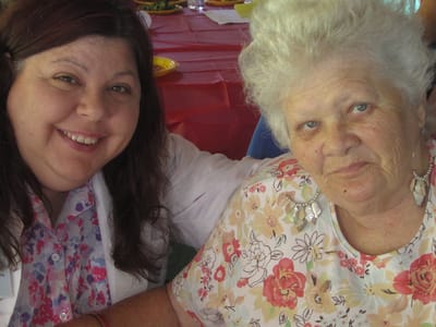 Staff member with resident at a festive gathering