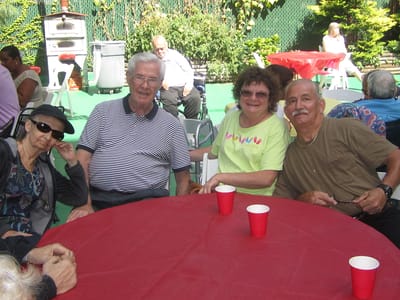 Residents enjoying an outdoor social event at tables