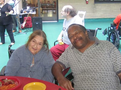 Two residents enjoying a meal together outdoors