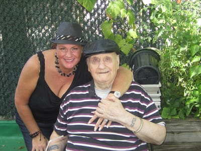 An elderly resident and staff member enjoying outdoor time together