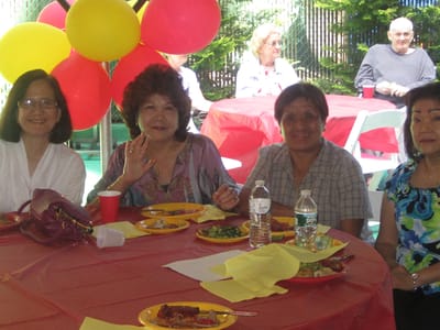 Residents enjoying a meal at an outdoor celebration