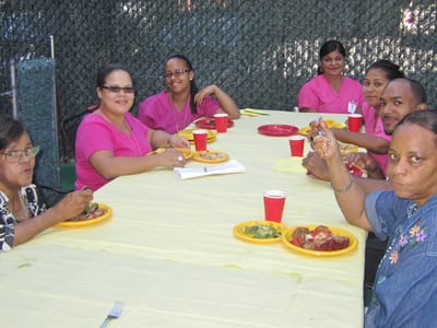 Residents and staff enjoying a meal outside