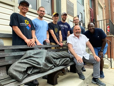 Volunteers gathering outside the facility on a bench