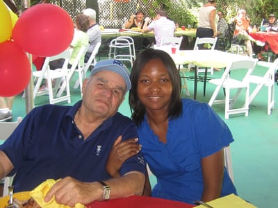 A resident and staff member enjoying an outdoor event