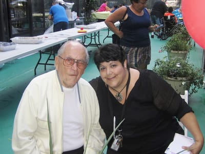 Resident and staff celebrating outdoors at an event