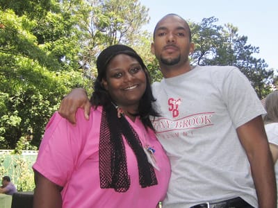 Staff member posing outdoors with a resident