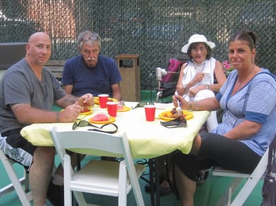Residents enjoying a meal outside at a social gathering