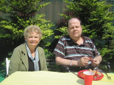Two residents enjoying a meal outdoors