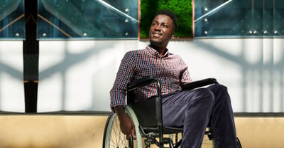 Man in a wheelchair enjoying sunlight indoors