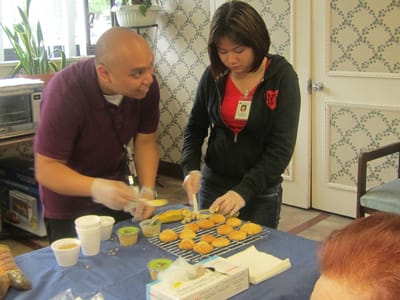 Residents baking cookies in an activity area