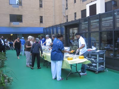Residents and staff enjoying an outdoor food event