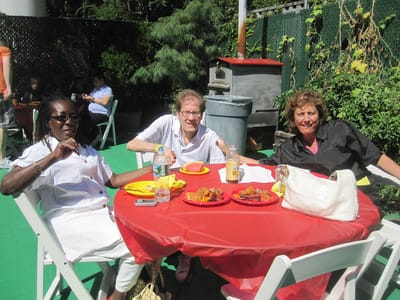 Residents enjoying a meal outdoors at a picnic table