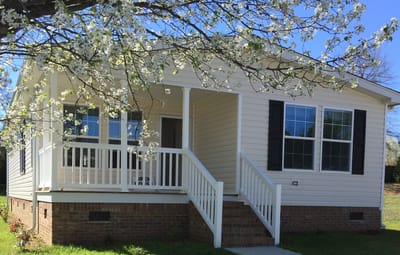 Exterior view of a facility building with blooming trees