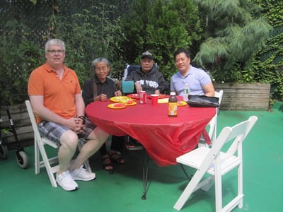 Residents and staff enjoying a meal outdoors