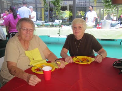Two residents enjoying a meal outdoors