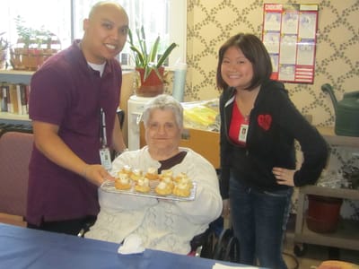 Staff and resident enjoying food activity in activity room