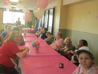 Residents enjoying a celebration in a common area