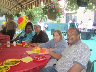 Residents enjoying a meal at an outdoor celebration