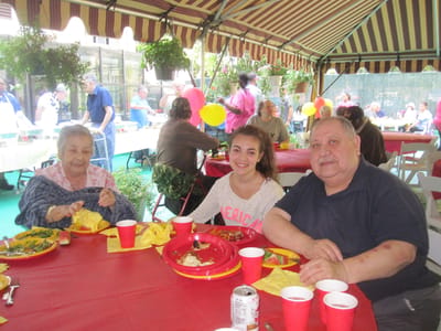 Residents enjoying a meal at an outdoor gathering