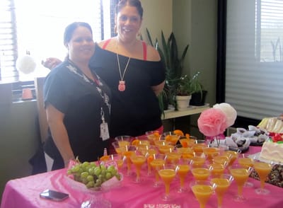 Staff posing with dessert arrangements at an event