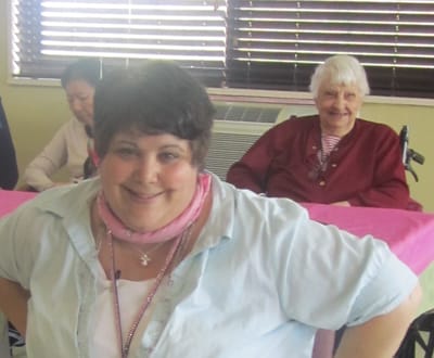 Resident interacting with caregiver in a common area